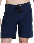 model wearing mens ben carlson eject 18.5" straight in navy. front view with tie and yellow stitching