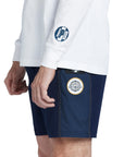 side view of circular ipd logo on wrist of white mens ben carlson long sleeve tree