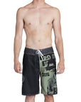 model wearing mens faceplant y2k fit 22" boardshort in black showing large graphic on left leg with woman surrounded by IPD logos and lerge IPD on right leg and tie closure on waist