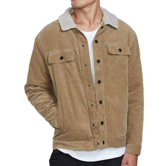 The front view of a man wearing a khaki button up corduroy jacket with two chest pockets. His right hand is in the right front pocket above the waist.