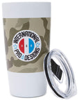 Front view of a tumbler with lid. The tumbler has a camouflage print wrapping around it with a white circular logo on the front. The logo has the letters U S A in the middle in red, white, and blue. Arching above the letters is the word International. Arching below the letters are the words Pro Designs with stars separating the words.