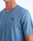 Front side view of a light blue polyester water resistant short sleeve Low Key Surf Shirt with a small I P D logo over the heart.