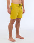 The B100 Chase boardshort features a 16” length and solid yellow coloring with a black and white striped side taping. It also has a waistband tie, side zipper pocket, and a black IPD logo patch halfway up the left leg taping.