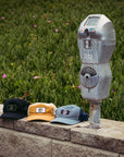 dusty blue.    Three  1697 trucker hat sit on a wall next to a parking meter. 