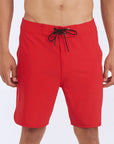 Front view of red 83 board shorts featuring a zigzag interior stitch waistband and signature metal rivet.