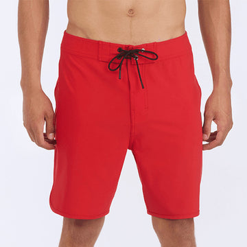 Front view of red 83 board shorts featuring a zigzag interior stitch waistband and signature metal rivet.