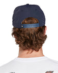 A young man wearing an Atlas navy hat, back view, displaying the adjustable strap and the back design of the hat.