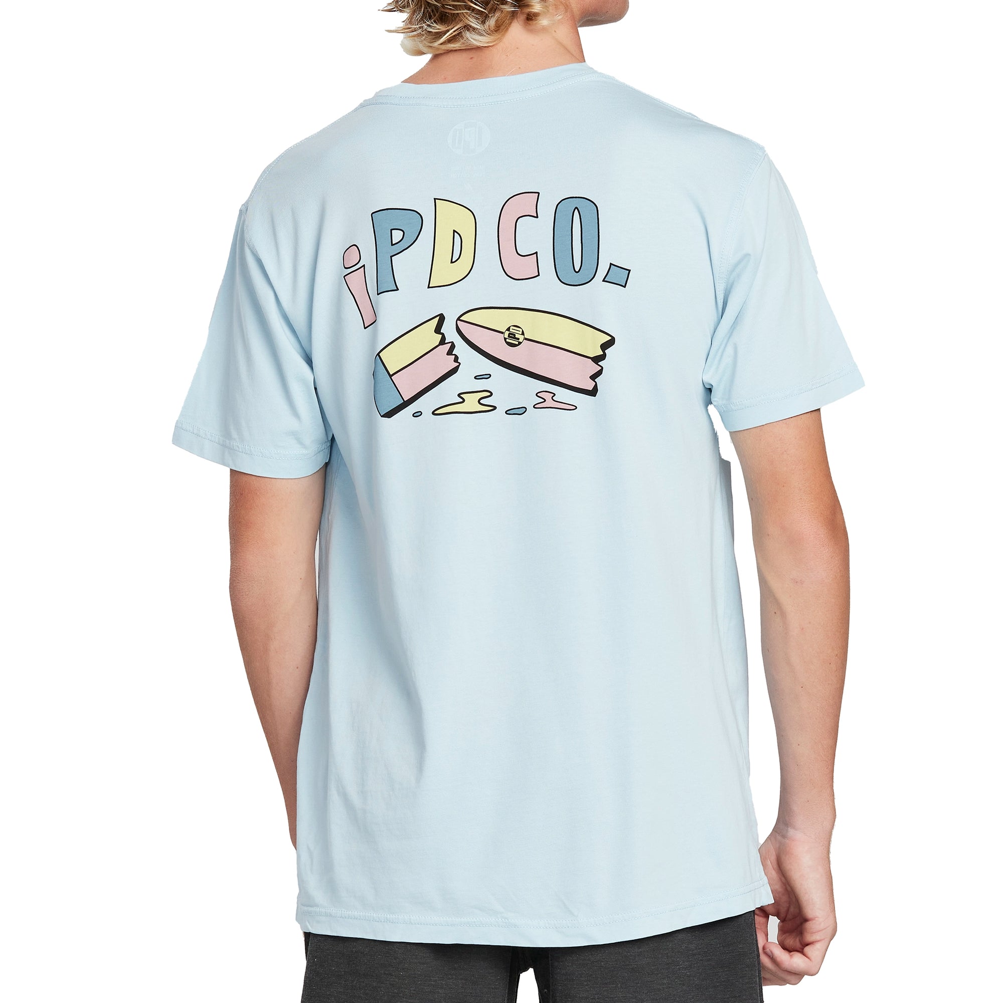 Back of a lemonade yellow short sleeve tee with a large print of a cartoon surfboard broken in half. Above the broken surfboard are the letters I P D C O period in a cartoonish font.