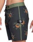 Black boardshorts with green trim and floral pattern side.