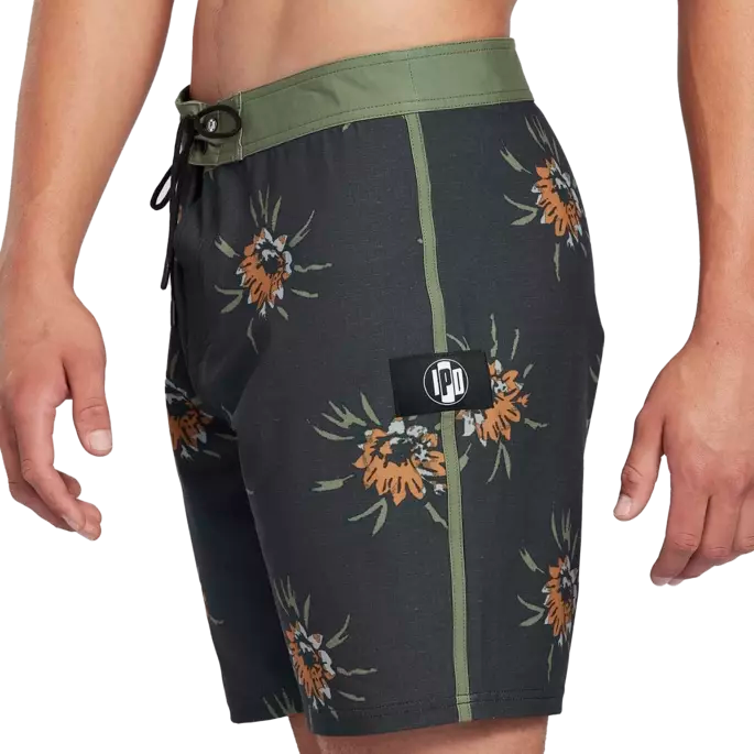 Black boardshorts with green trim and floral pattern side.