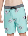 Tulum turquoise boardshorts with dark gray lining and a floral pattern front.