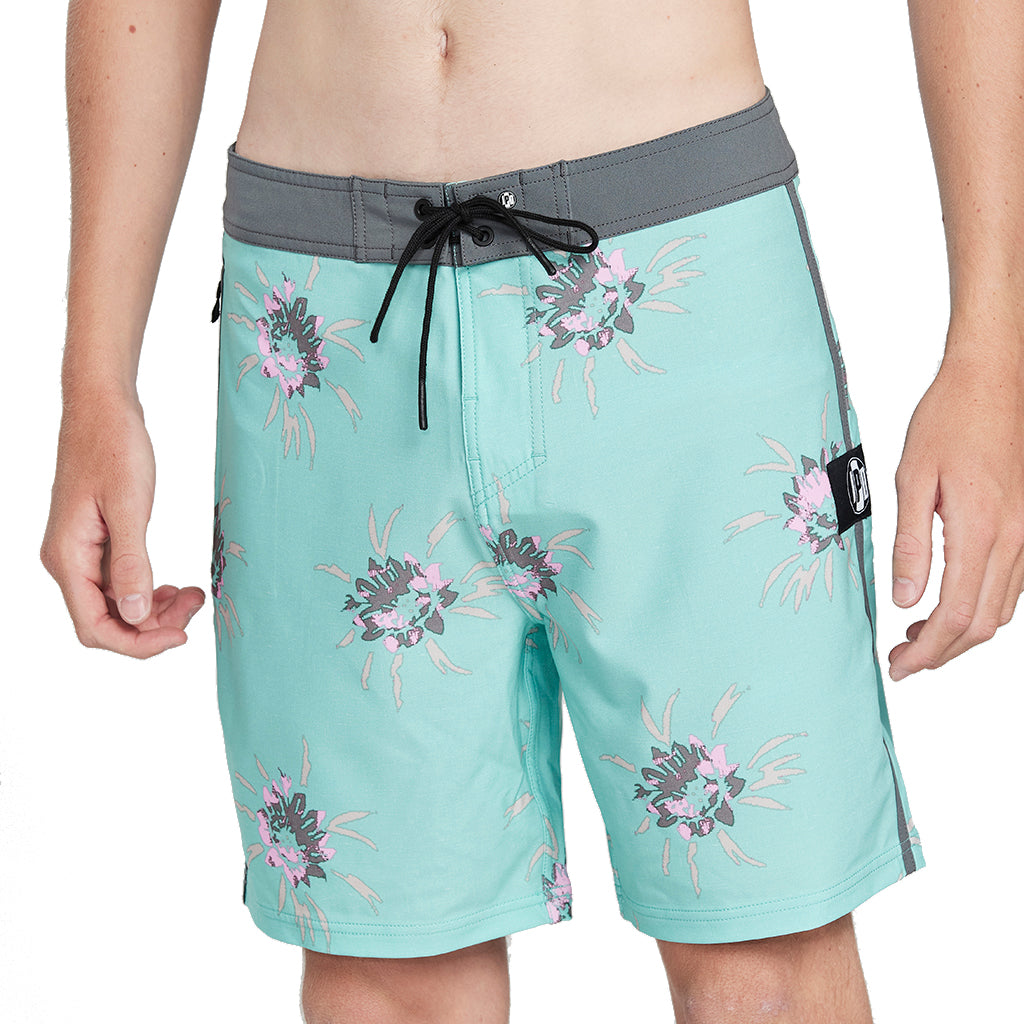 Tulum turquoise boardshorts with dark gray lining and a floral pattern front.