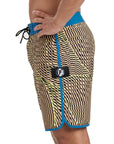 Side view of black and yellow abstract striped boardshorts mimicking sound frequency with light blue trim and an I P D logo on the side.