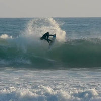 levi whipping around a tight backside snap off the lip of a wave