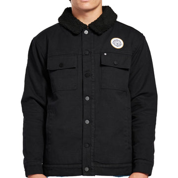 Front view of a black long sleeve heavyweight cotton button up jacket. It has a thick, cotton-lined collar with two patch flap pockets on each side of the chest. Above the left pocket is a white circular patch.