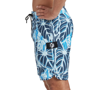 Banjo blue boardshorts with a large abstract beige offset floral print front view. 