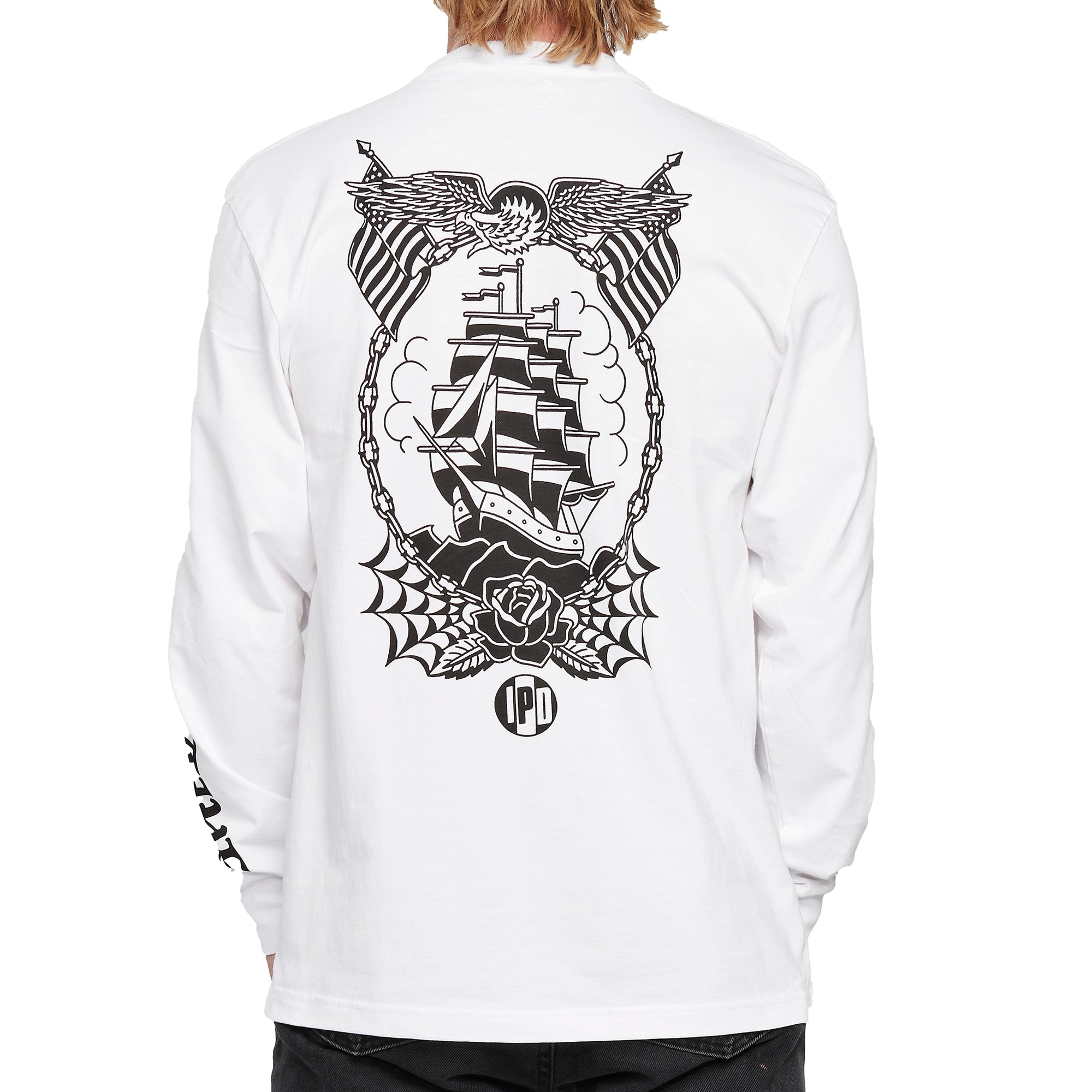 Back view of a white long sleeve tee with a large printed black emblem of an old ship sailing at sea. Above the emblem is an eagle spreading its wings with two American flags on each side. Below the emblem is a rose with symmetrical spider webs on each side. The I P D logo is below.