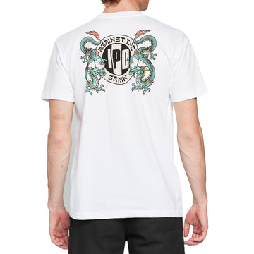 Back view of a white short sleeve tee with a large I P D logo with the words Against the arching above, the word Grain arching below, and two green dragons on each side of the logo.