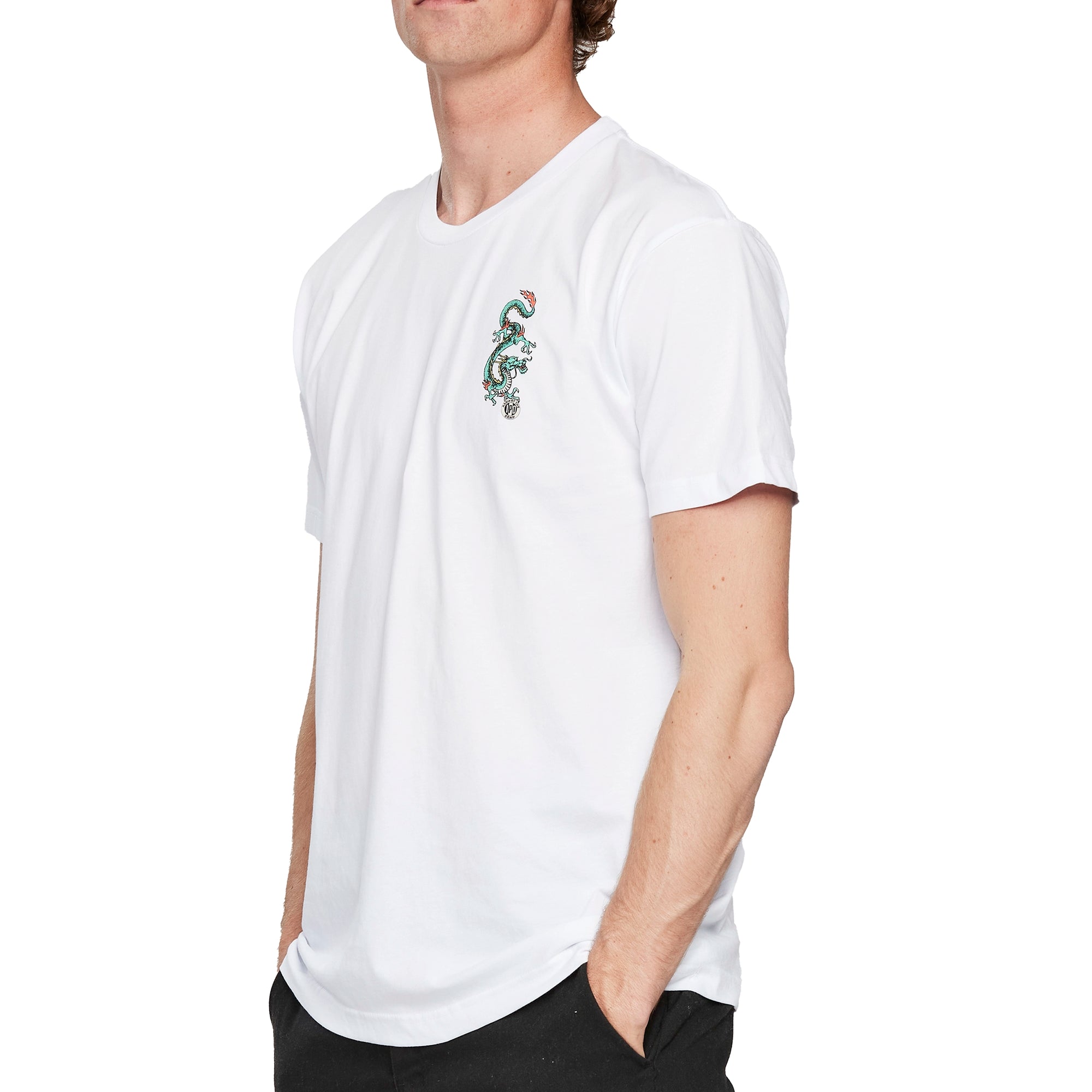 Back view of a white short sleeve tee with a large I P D logo with the words Against the arching above, the word Grain arching below, and two green dragons on each side of the logo.