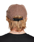 A young man wearing a Paradise brown hat, back view, displaying the adjustable strap and the back design of the hat.