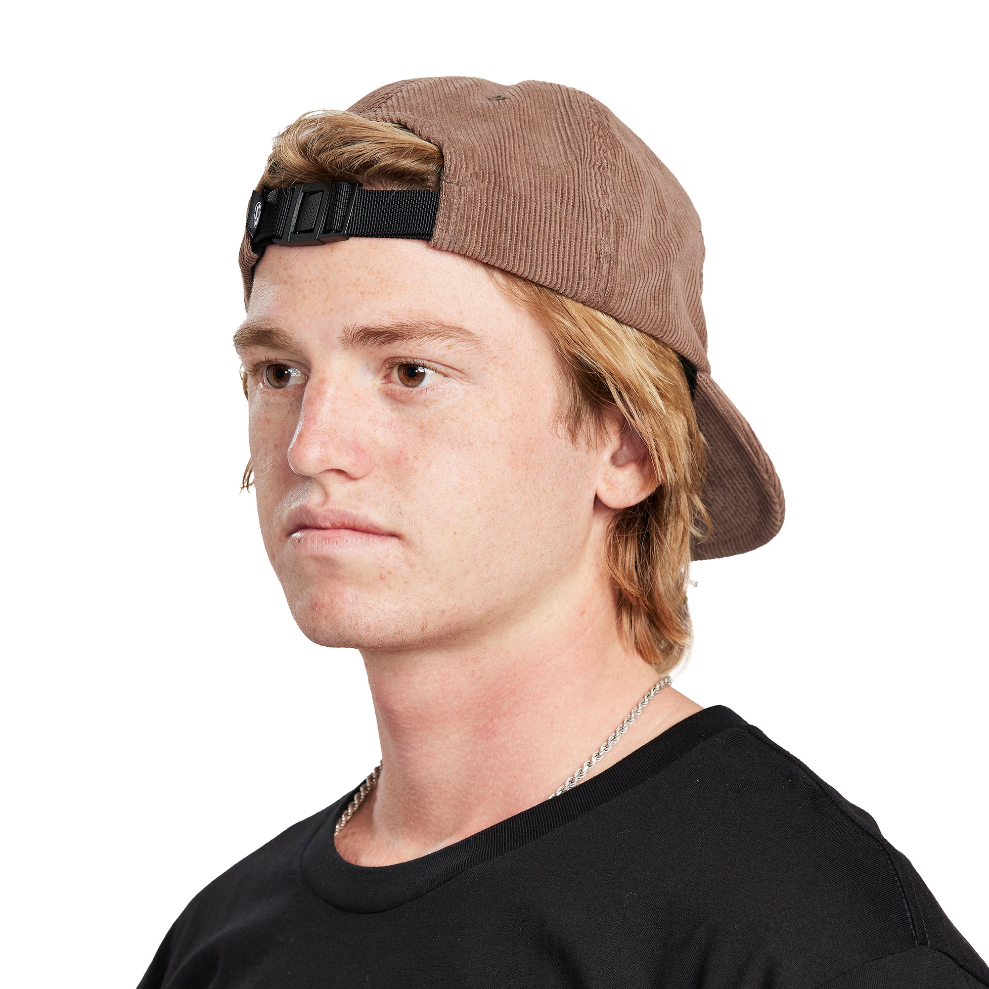  A young man wearing a Paradise brown hat, side view, illustrating the side profile and design of the hat.