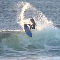 reef throwing a big frontside snap on the lip of a wave
