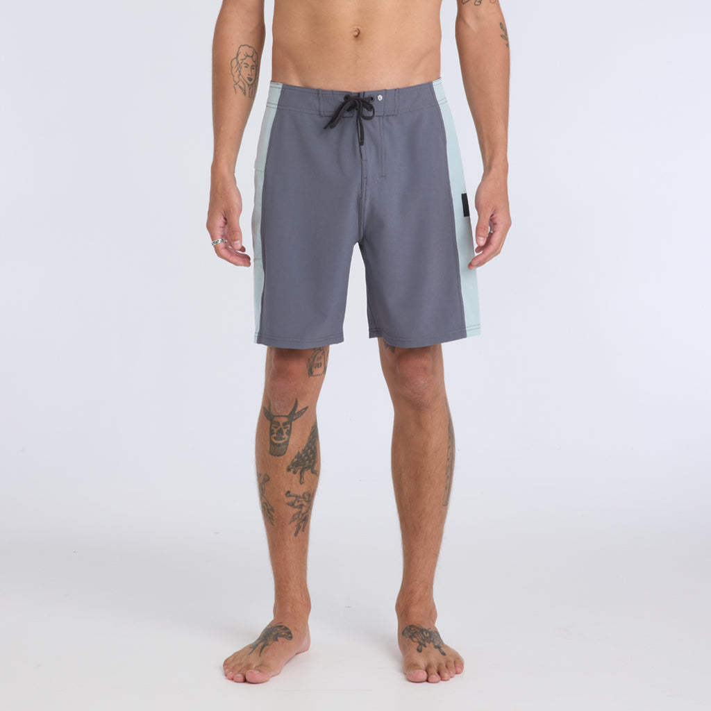 Front view of dark gray boardshorts with light gray stripes on the side and a black elastic tie on the waistband.