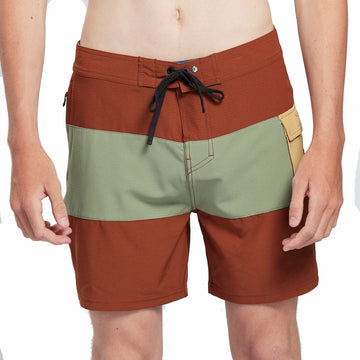 Burnt red boardshorts with a large olive green stripe through the middle and a tan side pocket front view.