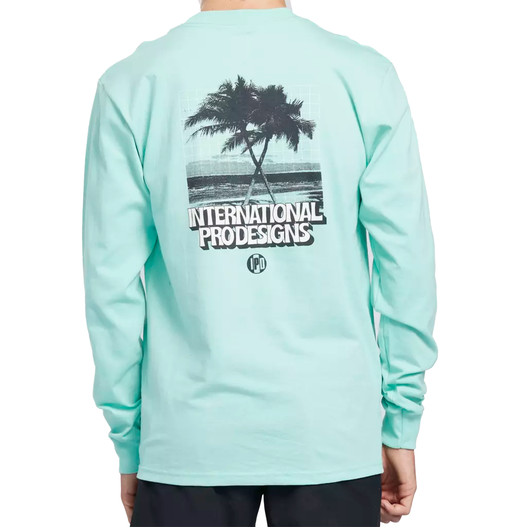 Tulum teal long sleeve tee with a print of crossing palm trees on a beach on the back.