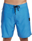 Front view of simple, solid blue boardshorts with a classic style and small I P D logo on the side.