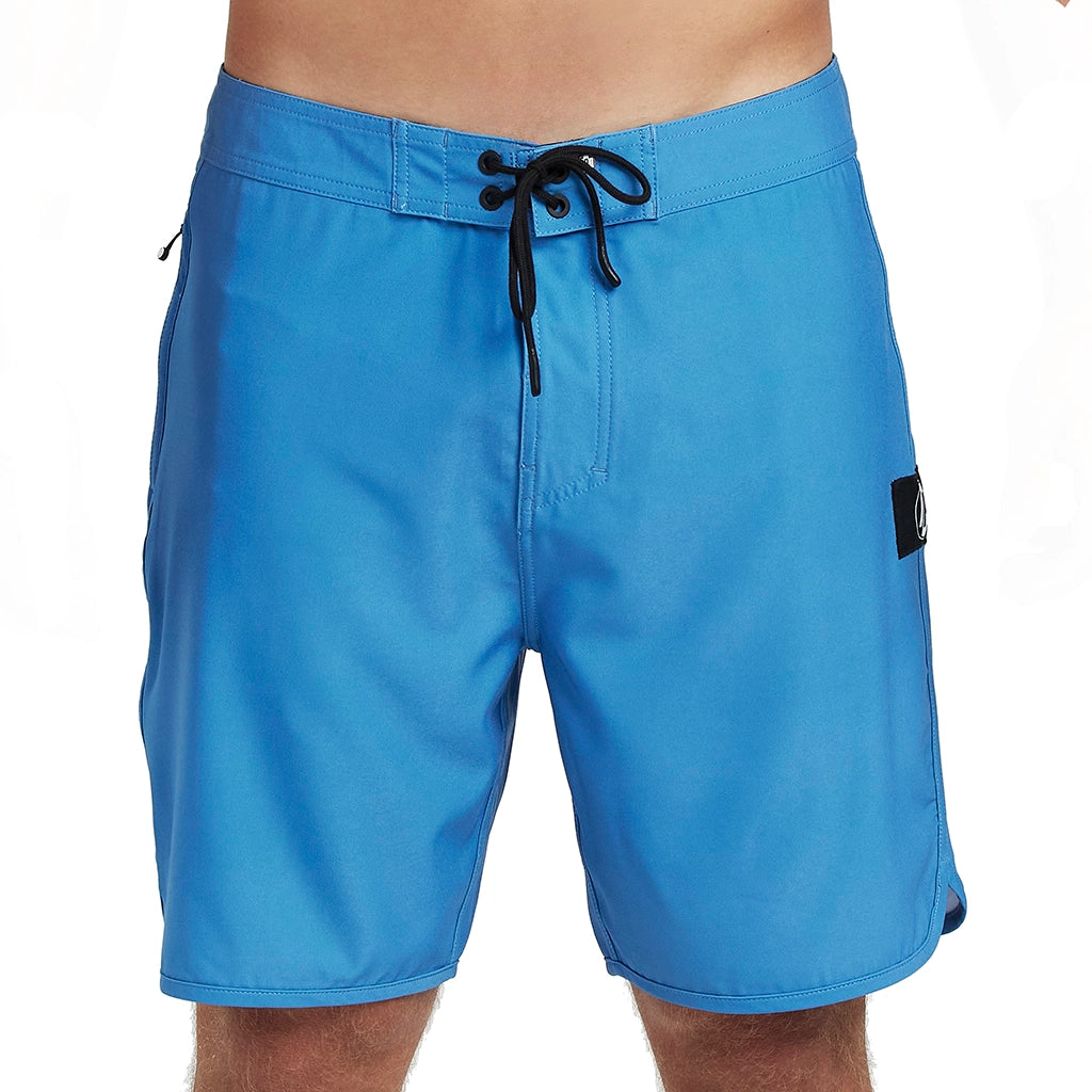 Front view of simple, solid blue boardshorts with a classic style and small I P D logo on the side.