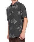 Side view of a black short sleeve shirt with white palm tree print, showcasing the laid-back fit and comfortable style.