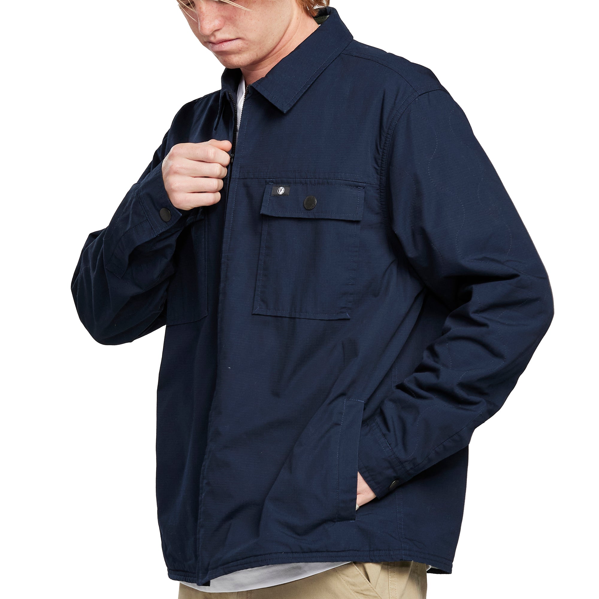 Side view of a man wearing the IPD Dispatch jacket, showing the practical pockets.