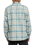 Back view of a man wearing the IPD Evergreen flannel shirt in blue with a plaid pattern.