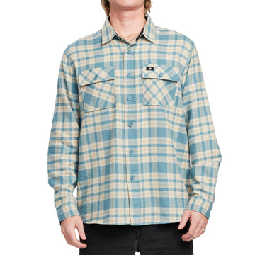 Front view of a man wearing the IPD Evergreen flannel shirt in blue with a plaid pattern.