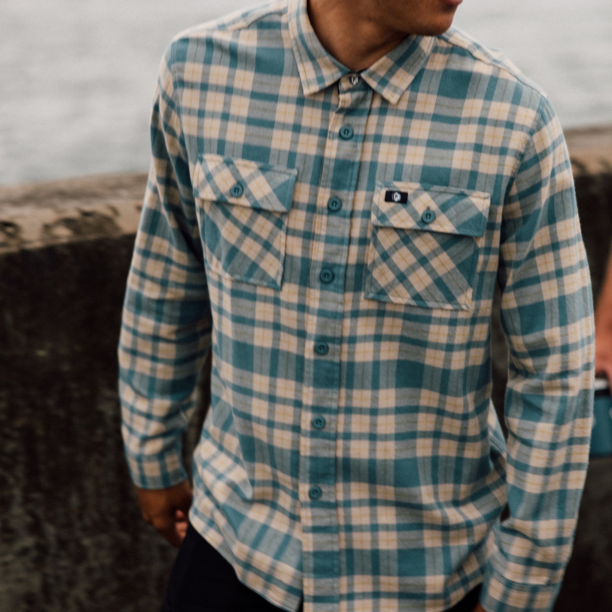 Man wearing the IPD Evergreen flannel shirt in blue in an outdoor setting.