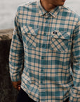 Man wearing the IPD Evergreen flannel shirt in blue in an outdoor setting.