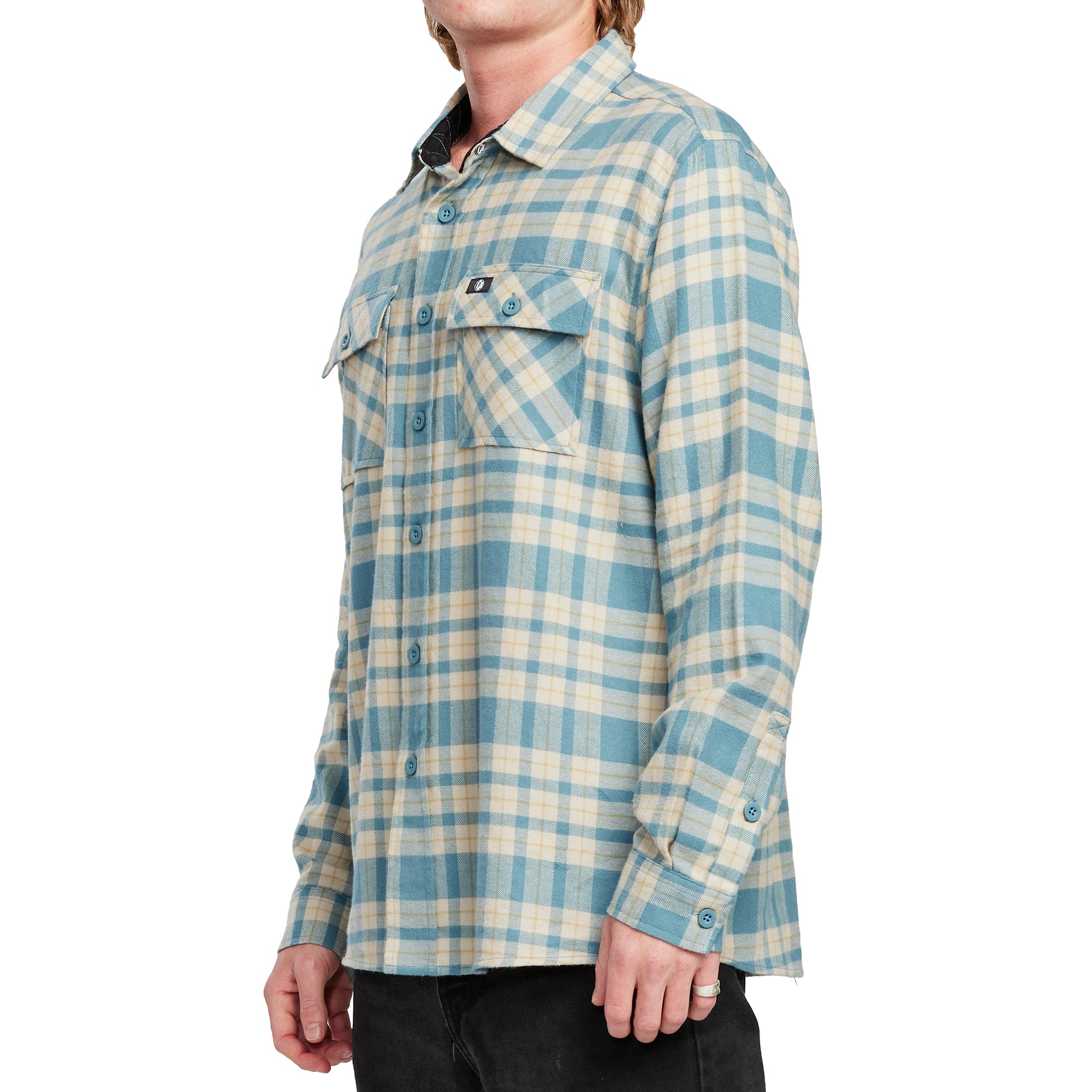 Side view of a man wearing the IPD Evergreen flannel shirt in blue with a plaid pattern.