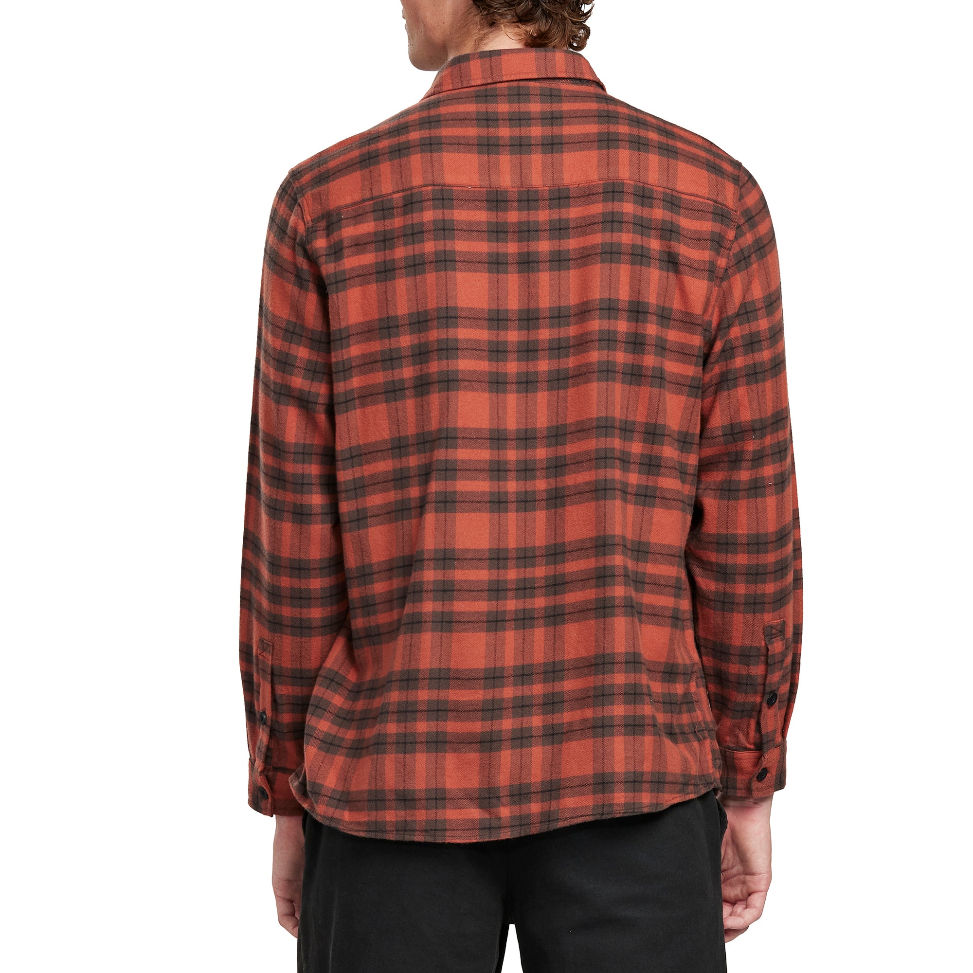 Back view of a man wearing the IPD Evergreen flannel shirt in burnt orange with a plaid pattern.