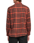 Back view of a man wearing the IPD Evergreen flannel shirt in burnt orange with a plaid pattern.