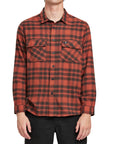 Front view of a man wearing the IPD Evergreen flannel shirt in burnt orange with a plaid pattern.