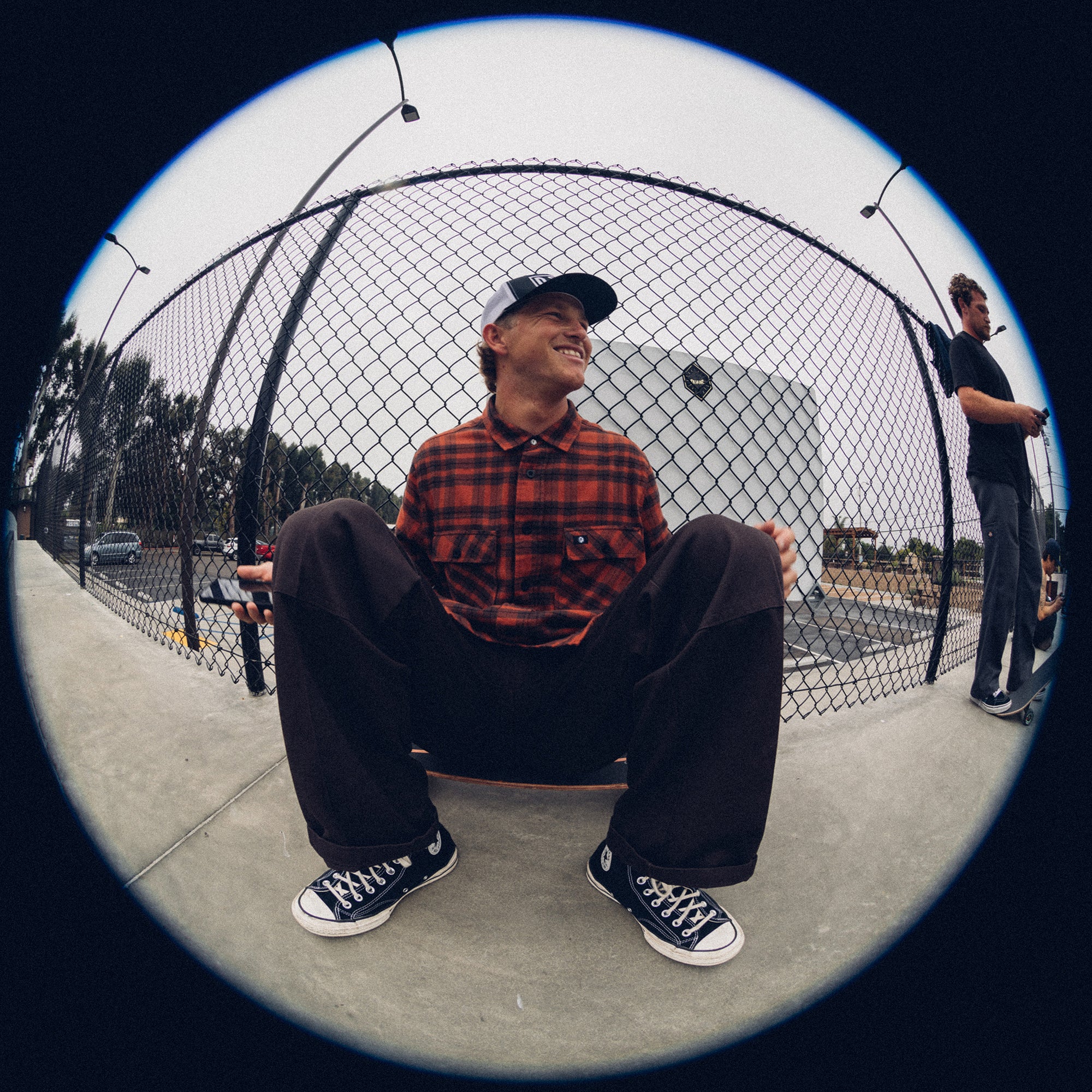 Man wearing the IPD Evergreen flannel shirt in burnt orange in an outdoor setting.