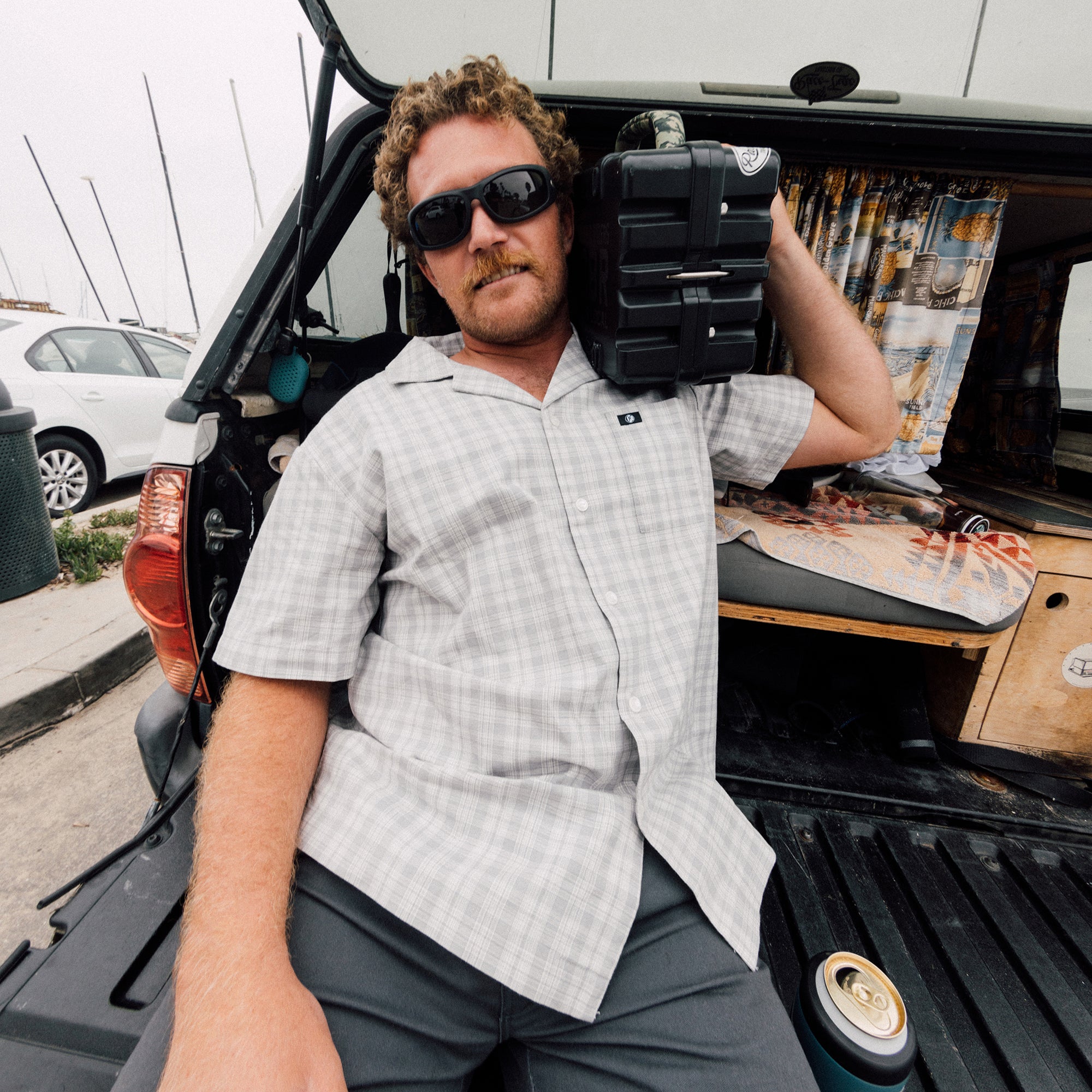 Man wearing the IPD Knox short sleeve shirt with a plaid pattern in a casual outdoor setting.