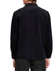 Back view of a man wearing the IPD Pierside corduroy shirt in black.