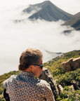 Man wearing the IPD Rudy short sleeve woven shirt in an outdoor setting with mountains in the background.