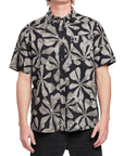 Front view of a man wearing the IPD Spinner short sleeve woven shirt with a black and gray floral pattern.