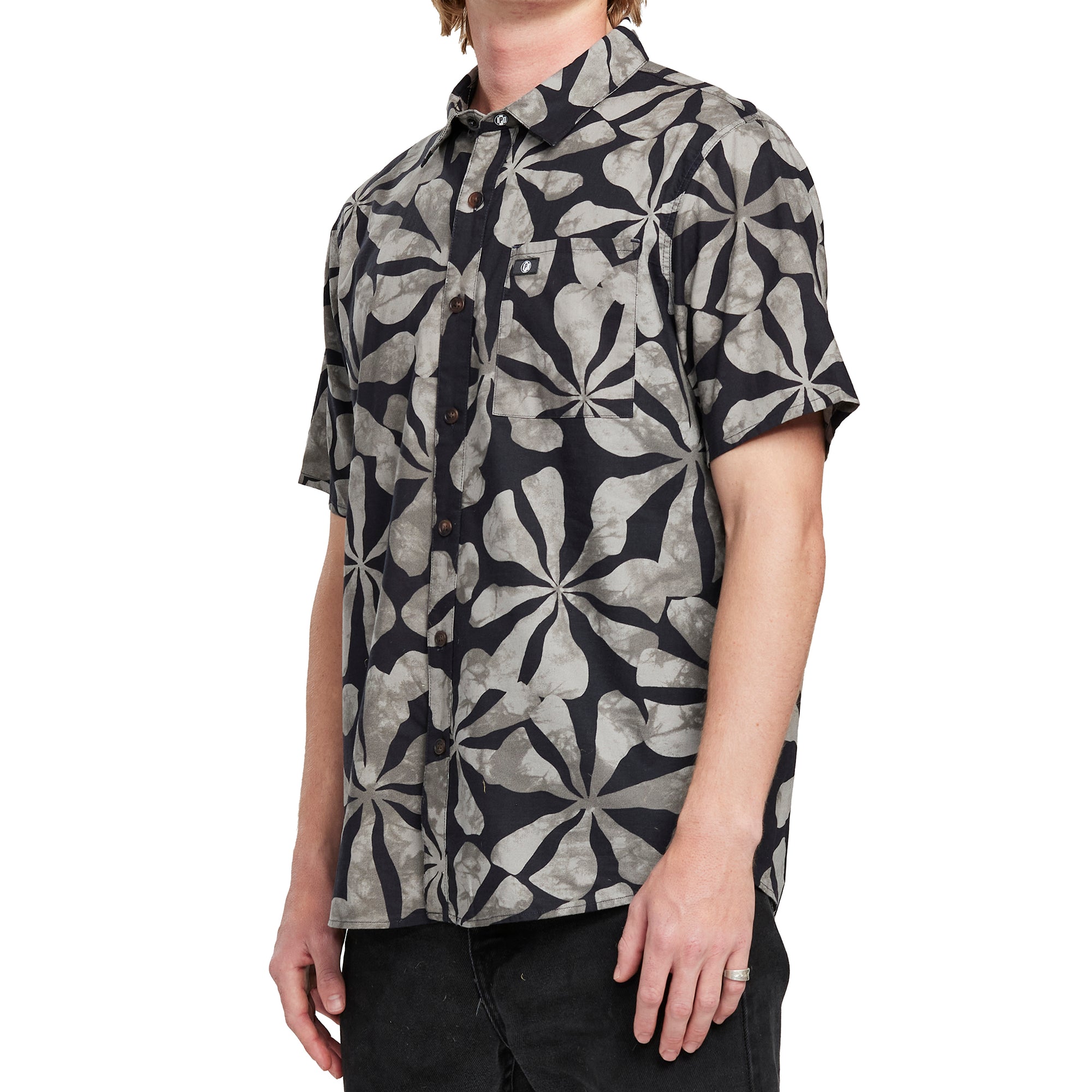 Side view of a man wearing the IPD Spinner short sleeve woven shirt, showing the black and gray floral pattern.