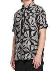 Side view of a man wearing the IPD Spinner short sleeve woven shirt, showing the black and gray floral pattern.