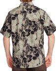 Back view of an olive short sleeve button-up shirt with black floral Hawaiian-inspired print, showcasing the relaxed fit and stylish design.