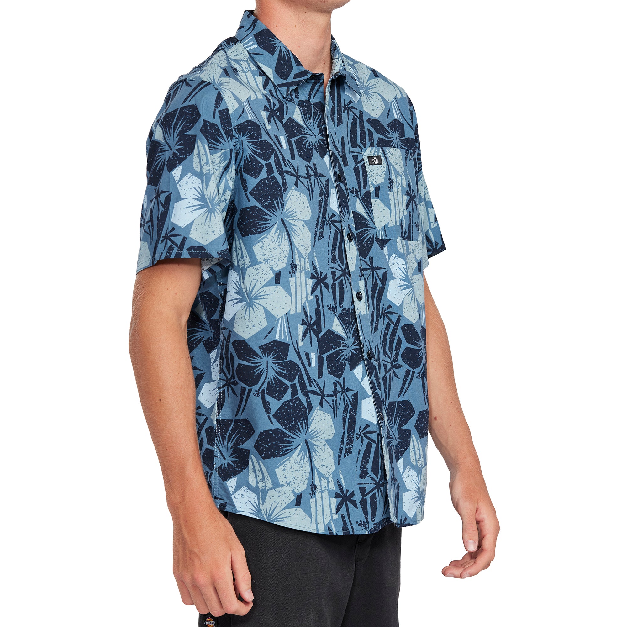 Side view of a Pacific blue Hawaiian print short sleeve shirt showcasing its detailed black and white floral design and comfortable fi